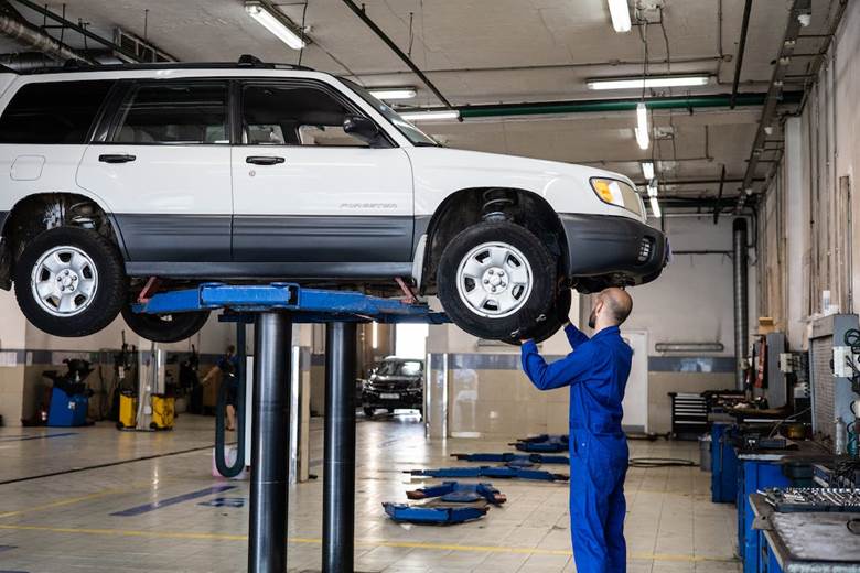 A man checking car wheels
