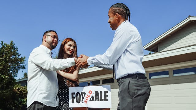 Man Shaking Hands with a Realtor during house sell